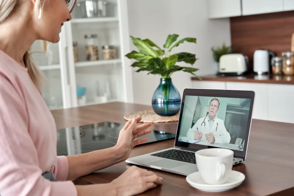 woman consults doctor via telemedicine technology utc